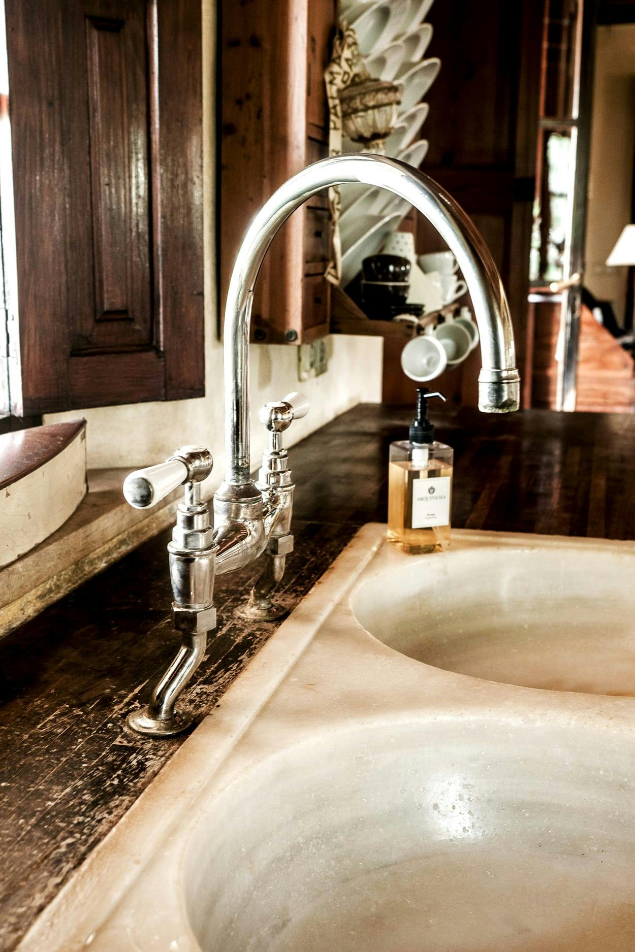 The image features a bathroom with a large, white sink and a marble countertop.