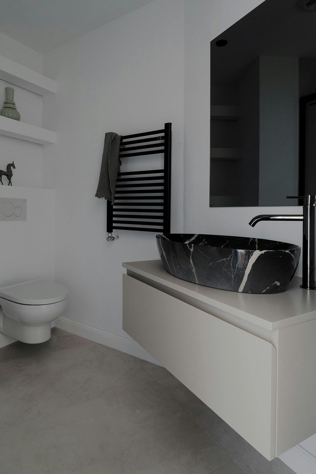The image features a modern bathroom with a white sink, toilet, and large mirror.
